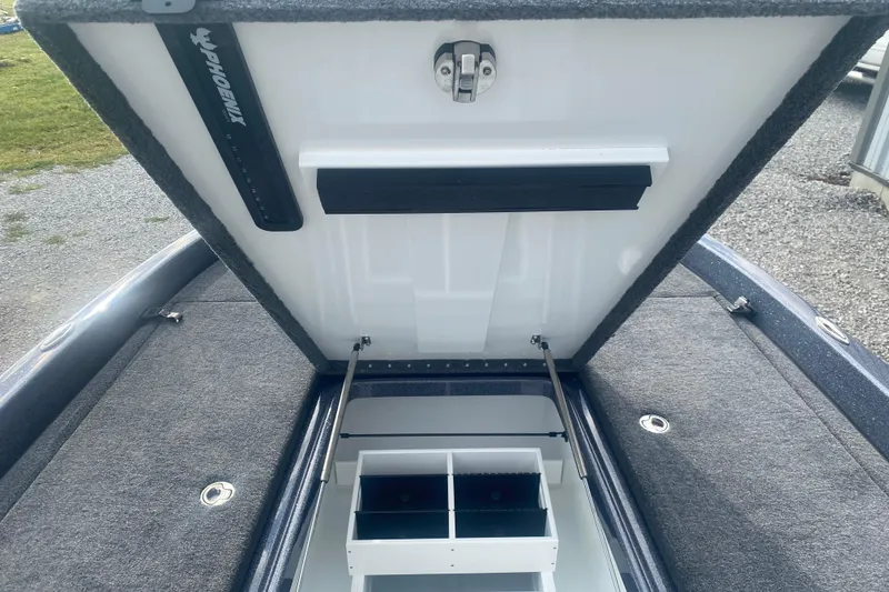 Slide: The Image of Open storage compartment of 2026 Phoenix 21 XE boat with organized interior sections. - 20