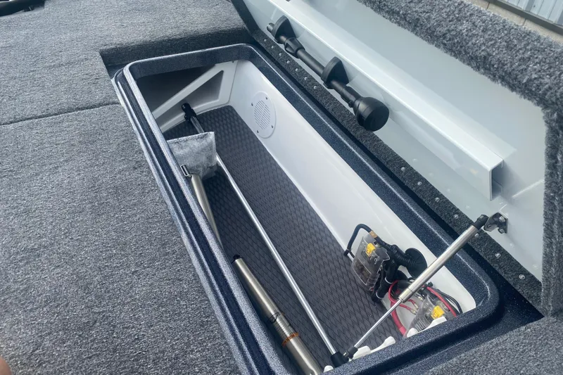 Slide: The Image of 2026 Phoenix 21 XE boat storage compartment with organized equipment and accessories. - 22
