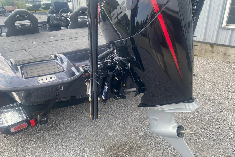 Slide: The Image of 2026 Phoenix 21 XE boat with powerful outboard motor, parked on gravel. - 7