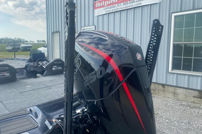 Slide: The Image of 2026 Phoenix 21 XE boat with powerful 250 HP engine, parked outside dealership. - 8