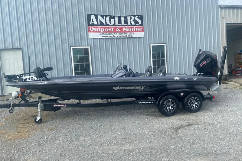 Slide: The Image of 2026 Phoenix 21 XE boat on trailer outside Anglers Outpost & Marine. - 9