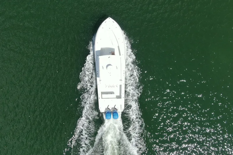 Slide: The Image of Aerial view of 2001 Regulator 32 Center Console boat cruising on water. - 11