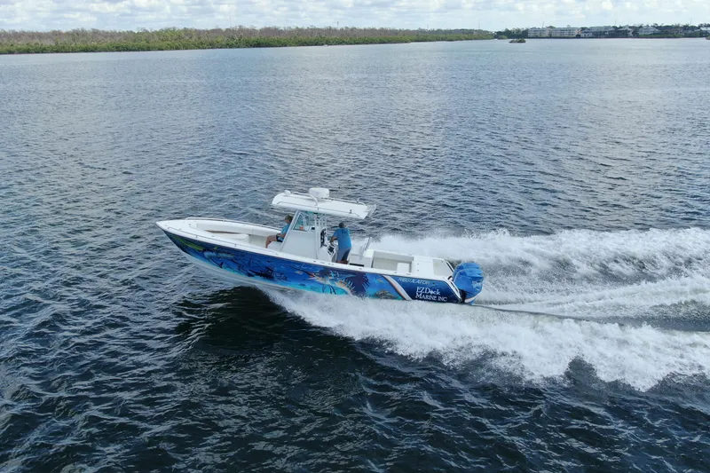 Slide: The Image of 2001 Regulator 32 Center Console boat cruising on open water. - 12