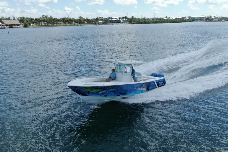 Slide: The Image of 2001 Regulator 32 Center Console boat cruising on a sunny day. - 16