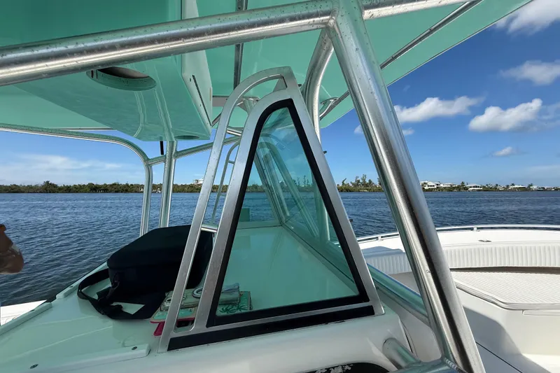 Slide: The Image of 2001 Regulator 32 Center Console boat on calm water, clear sky background. - 20