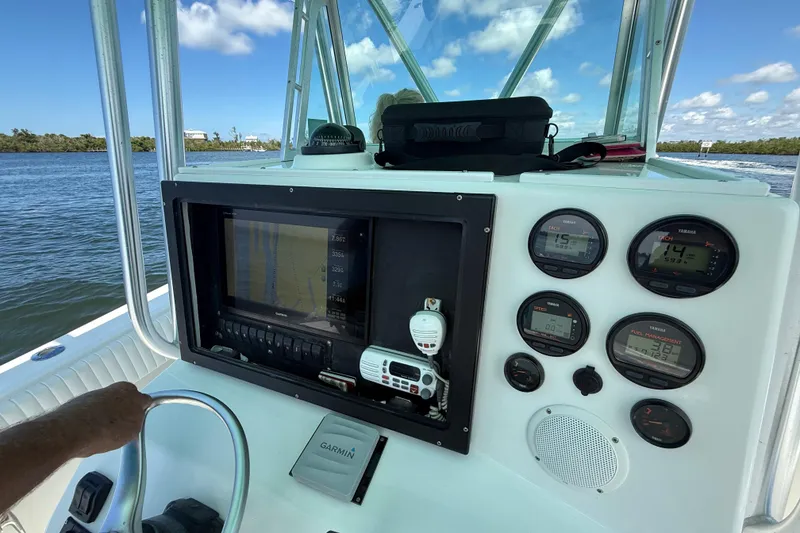 Slide: The Image of 2001 Regulator 32 Center Console dashboard with navigation and control instruments on a sunny day. - 23