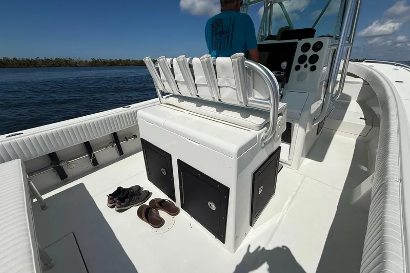 Slide: The Image of 2001 Regulator 32 Center Console boat interior with seating and storage, on a sunny day. - 25