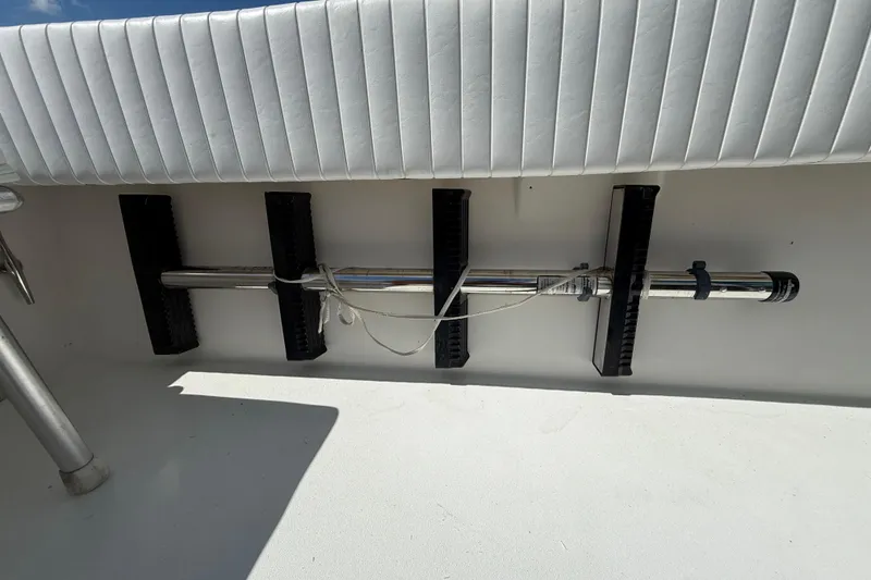 Slide: The Image of 2001 Regulator 32 Center Console boat interior with rod holder and cushioned seating. - 26