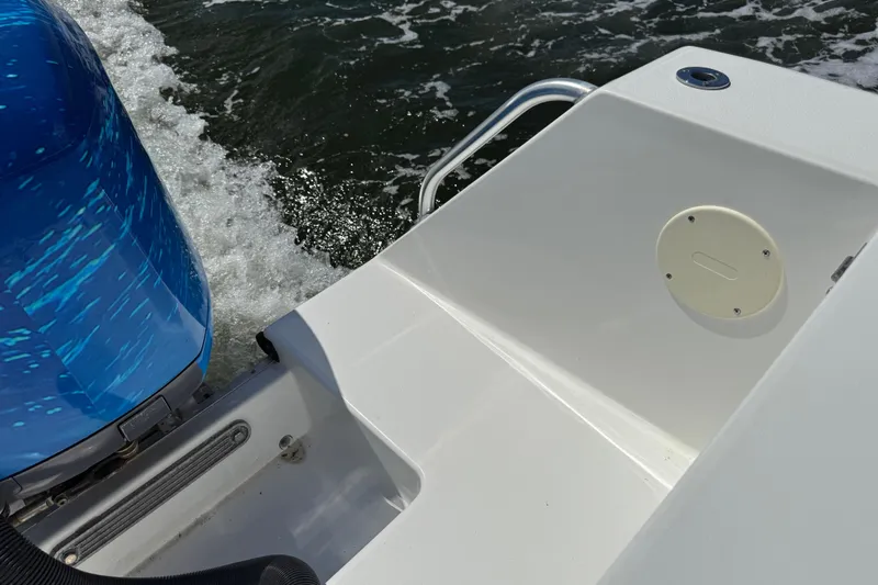 Slide: The Image of 2001 Regulator 32 Center Console boat with blue engine on water. - 27