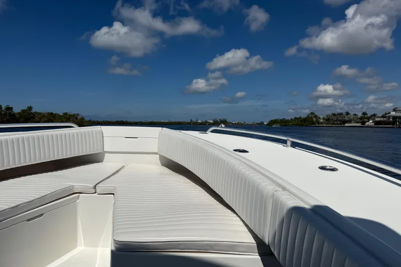 Slide: The Image of 2001 Regulator 32 Center Console boat with white seating, cruising on a sunny day. - 32
