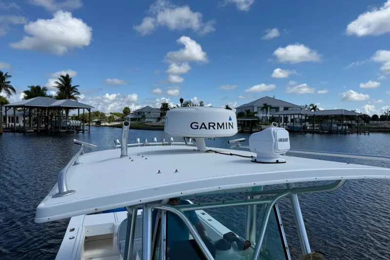 Slide: The Image of 2001 Regulator 32 Center Console with Garmin radar on calm waters, under a blue sky. - 35