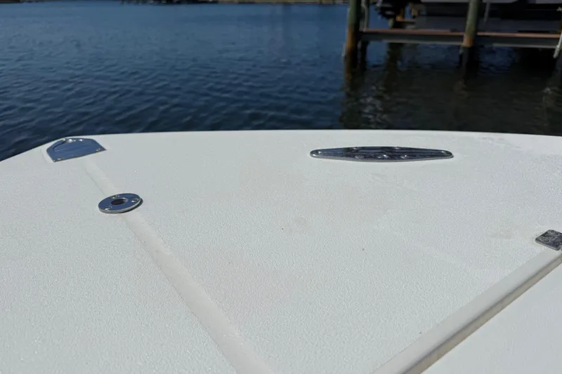 Slide: The Image of Bow of 2001 Regulator 32 Center Console boat on calm water. - 37