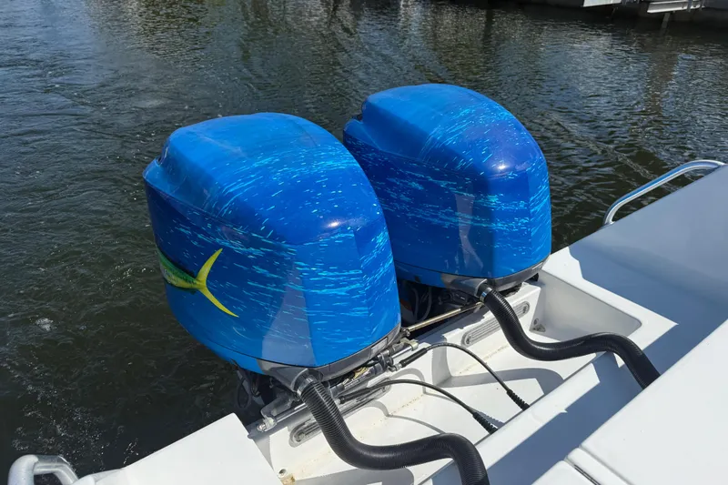 Slide: The Image of Twin blue outboard motors on a 2001 Regulator 32 Center Console boat. - 39