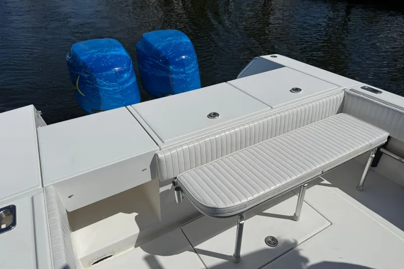 Slide: The Image of 2001 Regulator 32 Center Console boat with cushioned seating and twin engines. - 41