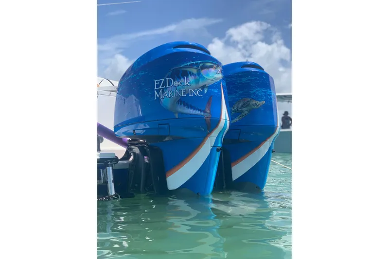 Slide: The Image of Twin outboard motors with marine graphics on a 2001 Regulator 32 Center Console boat. - 6