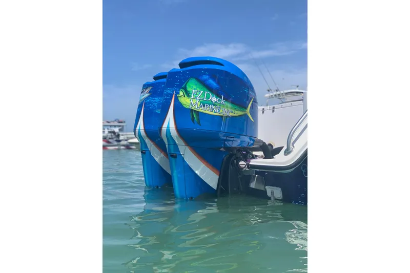 Slide: The Image of 2001 Regulator 32 Center Console with vibrant blue outboard motors in water. - 7