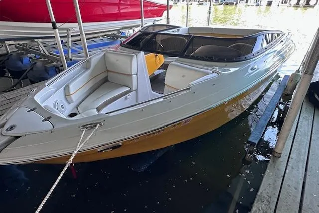 Slide: The Image of 2004 Four Winns 210 Horizon SS boat docked in a marina. - 2
