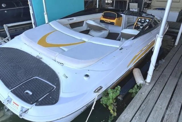 Slide: The Image of 2004 Four Winns 210 Horizon SS boat docked, featuring sleek design and spacious seating. - 3