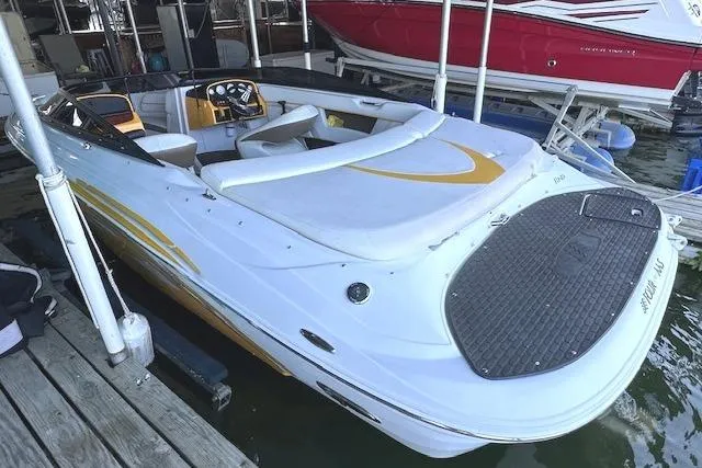 Slide: The Image of 2004 Four Winns 210 Horizon SS boat docked, featuring sleek design and spacious seating. - 5