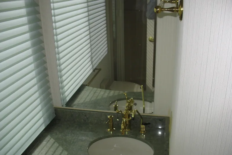 Slide: The Image of Bathroom interior of 1993 Skipper Liner houseboat with gold fixtures and blinds. - 10