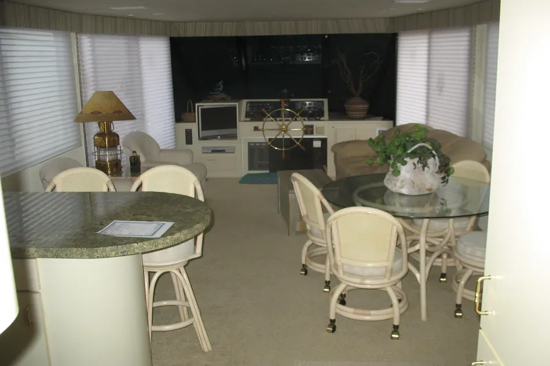 Slide: The Image of Interior of a 1993 Skipper Liner houseboat with dining area and helm station. - 12