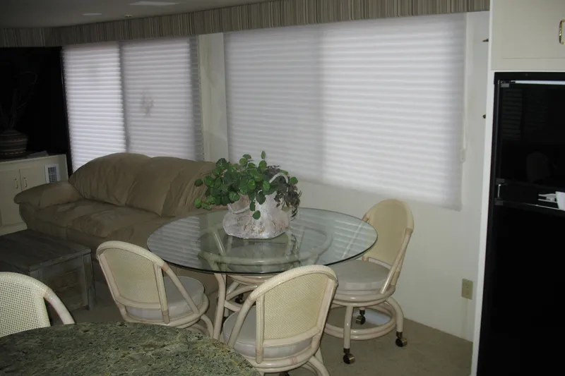 Slide: The Image of Interior of 1993 Skipper Liner houseboat with glass table, chairs, and sofa. - 14