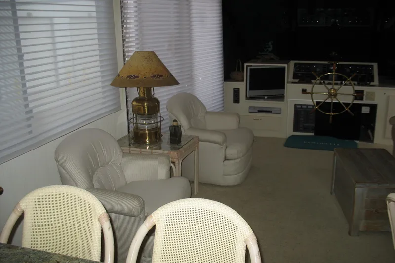 Slide: The Image of Interior of a 1993 Skipper Liner houseboat with cozy seating and nautical decor. - 16