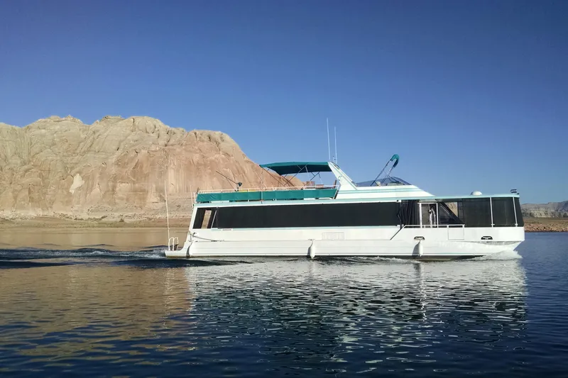 Slide: The Image of Houseboat cruising on a lake with rocky cliffs, Skipper Liner 1993 model. - 2