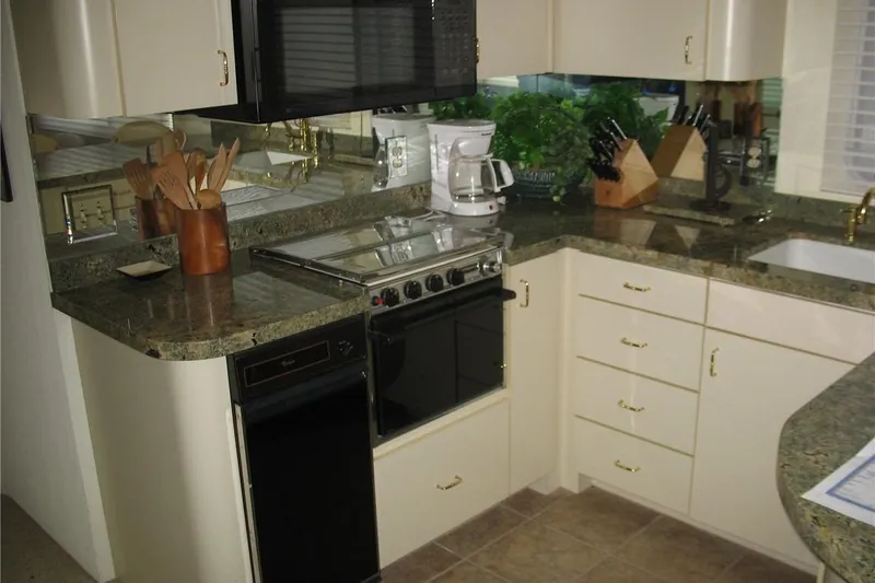 Slide: The Image of 1993 Skipper Liner houseboat kitchen with granite countertops and modern appliances. - 25