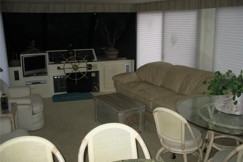 Slide: The Image of Interior of a 1993 Skipper Liner houseboat with cozy seating and nautical decor. - 27