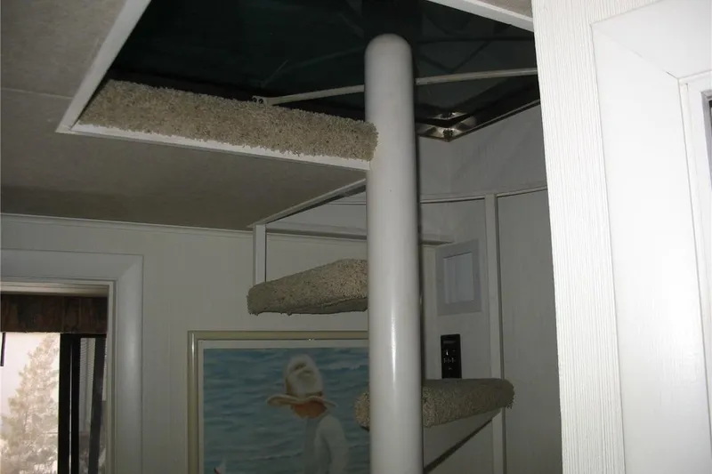 Slide: The Image of Interior of 1993 Skipper Liner houseboat with spiral staircase and wall art. - 28