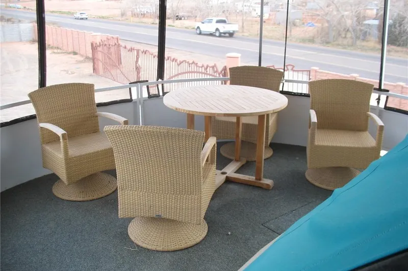 Slide: The Image of Outdoor seating area on a 1993 Skipper Liner houseboat with wicker chairs and round table. - 34