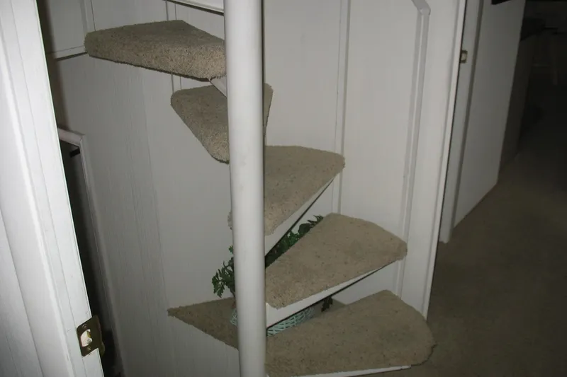 Slide: The Image of Spiral staircase inside 1993 Skipper Liner houseboat with carpeted steps. - 42