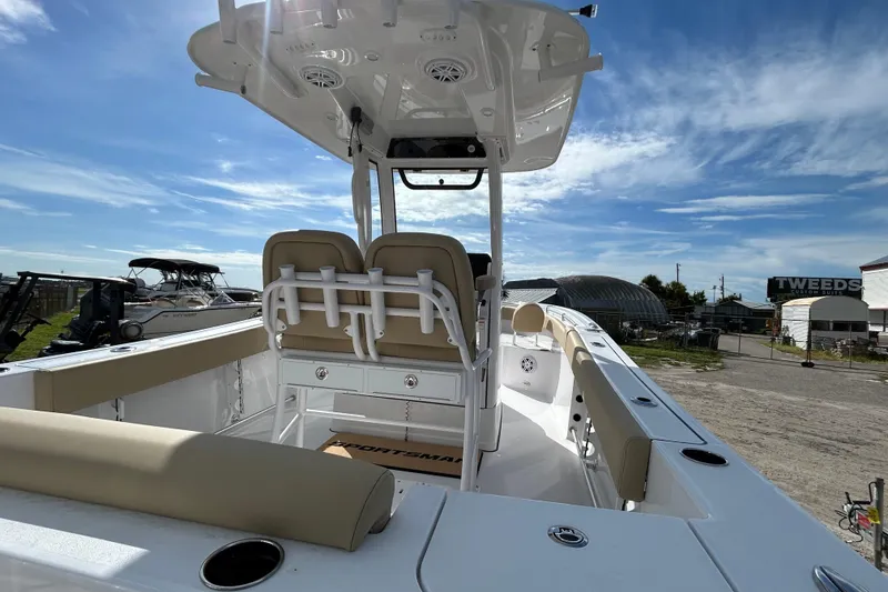 Slide: The Image of 2026 Sportsman Open 232 Center Console boat with seating and console, under a clear blue sky. - 8