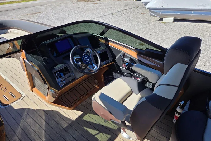Slide: The Image of 2026 Avalon Platinum Catalina 2785 Elite Windshield boat interior with modern steering and controls. - 10