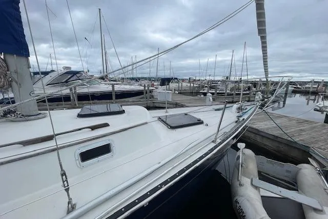 Slide: The Image of 1978 Hinterhoeller Niagara 35 Classic sailboat docked at a marina under cloudy skies. - 10