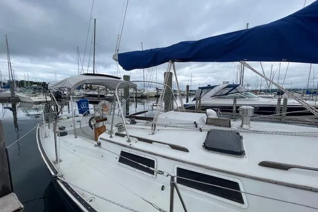 Slide: The Image of 1978 Hinterhoeller Niagara 35 Classic sailboat docked in a marina under cloudy skies. - 11