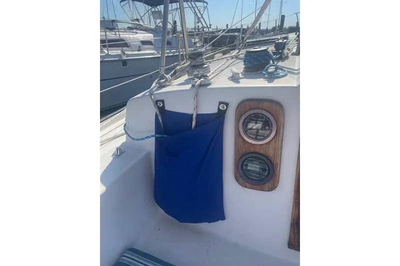 Slide: The Image of 1978 Hinterhoeller Niagara 35 Classic sailboat cockpit with blue storage bag and gauges. - 14