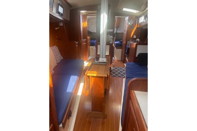 Slide: The Image of Interior of 1978 Hinterhoeller Niagara 35 Classic sailboat with wooden furnishings and blue seating. - 20
