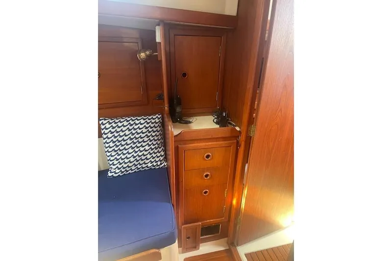 Slide: The Image of 1978 Hinterhoeller Niagara 35 Classic interior with wooden cabinetry and blue cushion. - 24