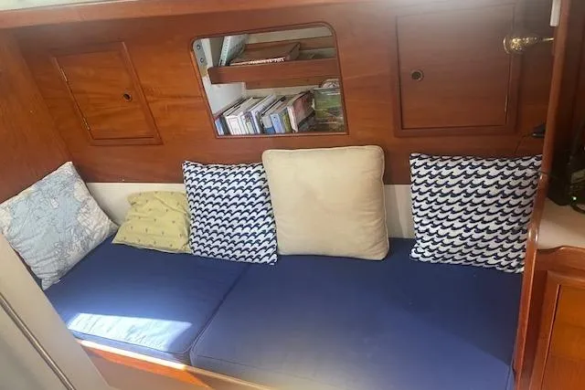 Slide: The Image of Cozy interior of 1978 Hinterhoeller Niagara 35 Classic sailboat with cushions and bookshelf. - 25