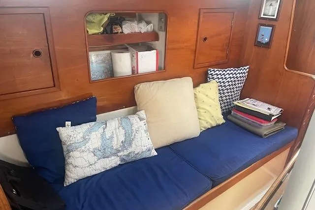 Slide: The Image of Interior of 1978 Hinterhoeller Niagara 35 Classic sailboat with cozy seating and cushions. - 26