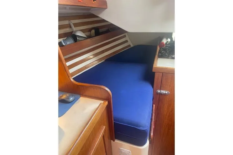 Slide: The Image of Cozy cabin interior of 1978 Hinterhoeller Niagara 35 Classic sailboat with blue cushions. - 28