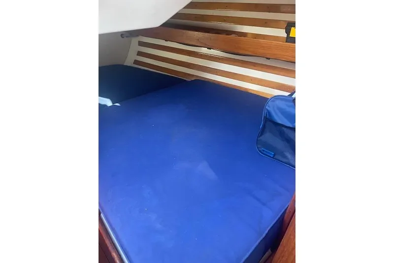 Slide: The Image of Interior cabin of 1978 Hinterhoeller Niagara 35 Classic sailboat with blue bedding. - 30