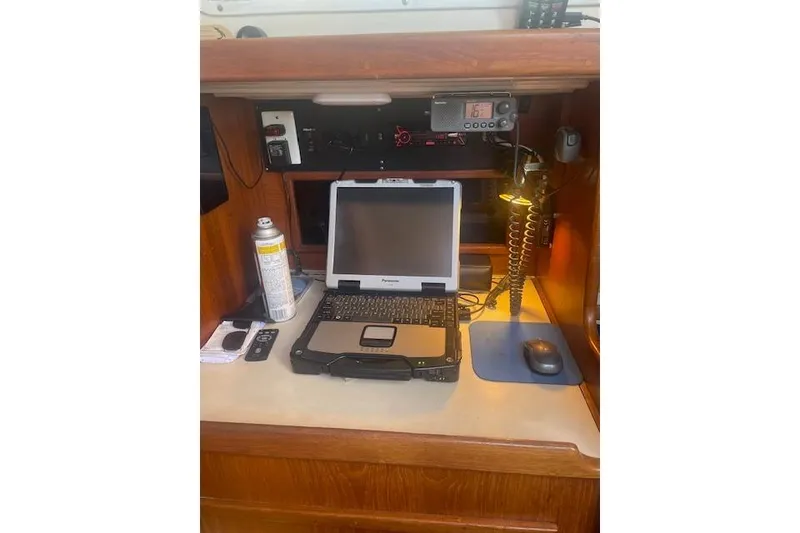 Slide: The Image of Navigation station with laptop and equipment on 1978 Hinterhoeller Niagara 35 Classic sailboat. - 39
