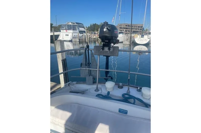 Slide: The Image of 1978 Hinterhoeller Niagara 35 Classic sailboat docked in a marina, featuring an outboard motor. - 4