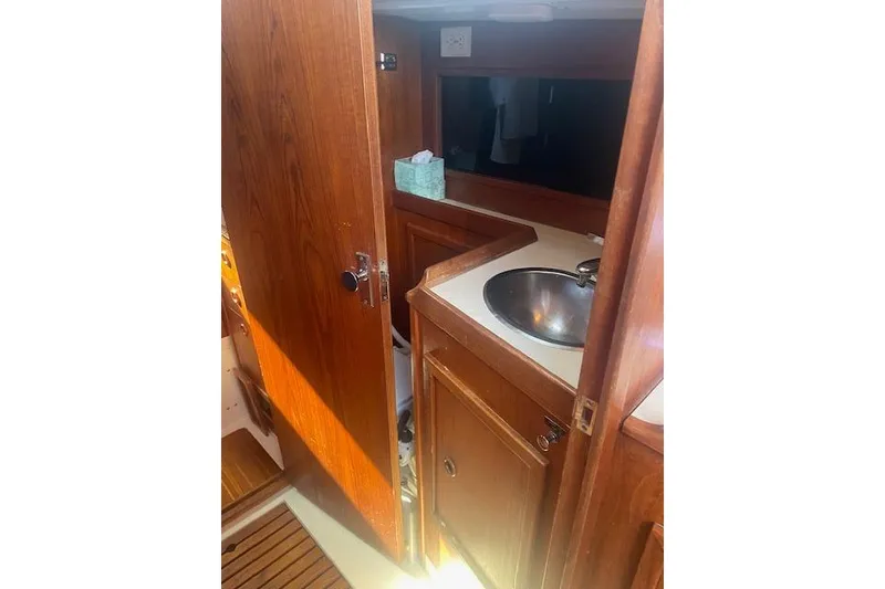Slide: The Image of 1978 Hinterhoeller Niagara 35 Classic yacht interior with wooden cabinetry and sink. - 40