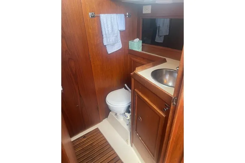 Slide: The Image of 1978 Hinterhoeller Niagara 35 Classic yacht bathroom with wooden cabinetry and compact sink. - 41