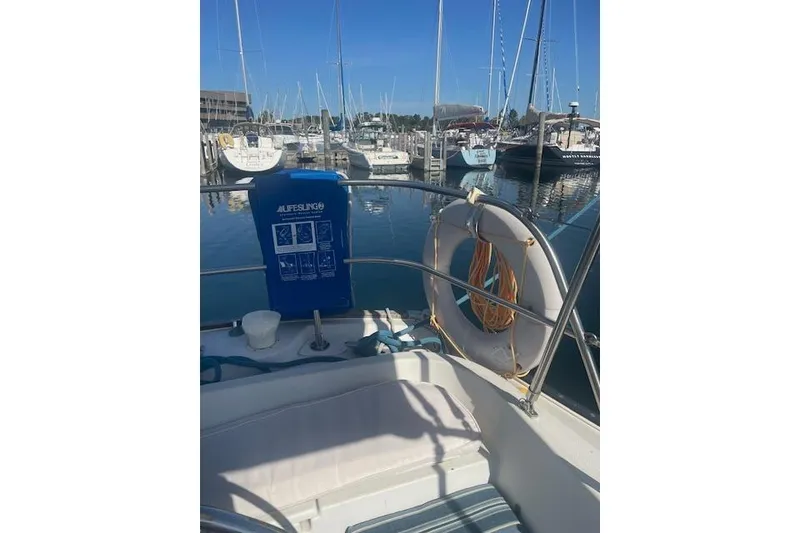 Slide: The Image of 1978 Hinterhoeller Niagara 35 Classic sailboat docked in marina, featuring lifesaving equipment. - 5