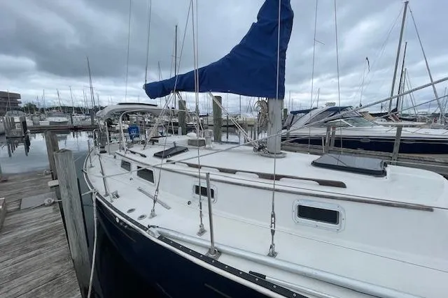 Slide: The Image of 1978 Hinterhoeller Niagara 35 Classic sailboat docked at marina under cloudy skies. - 9